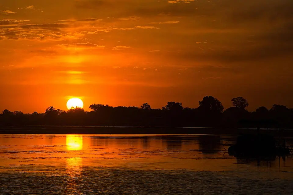Golden sunset reflecting across a calm Kenyan river